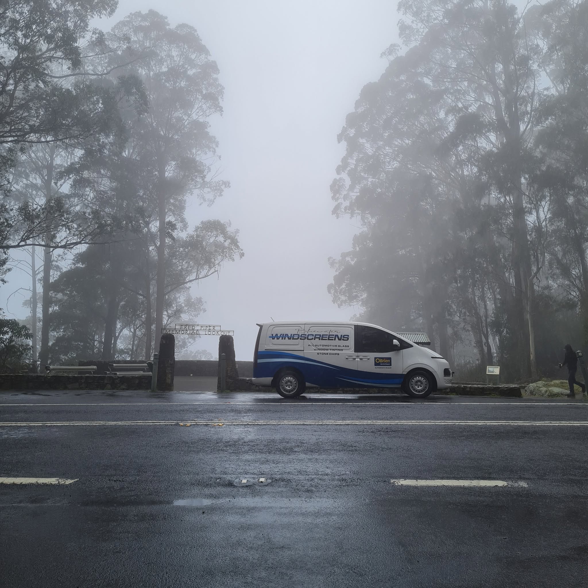 The Blue Water Windscreens van parked in thick fog at the Fred Piper Memorial Lookout on Brown Mountain