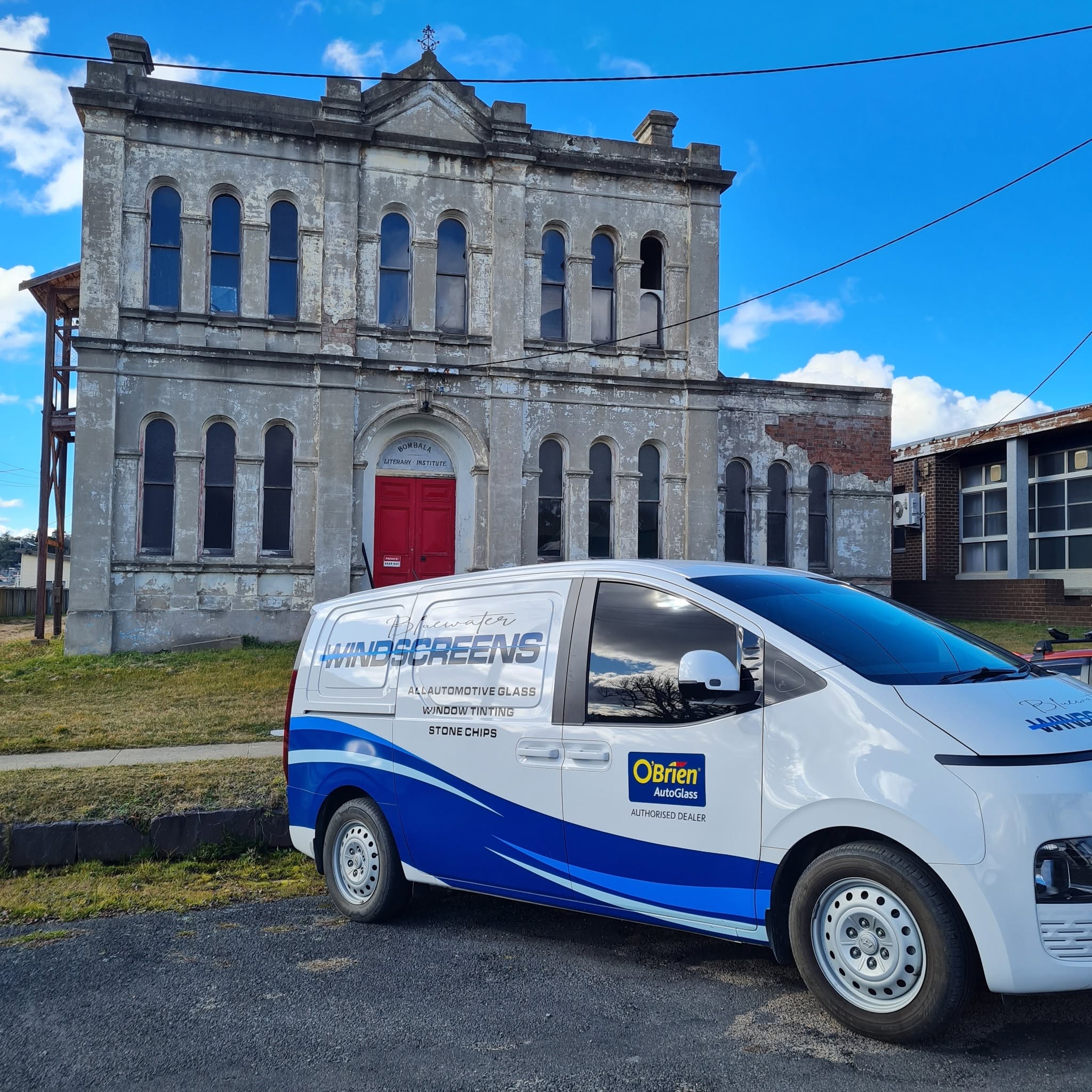 The signwritten van outside the old Bombala Literary Institute building on a clear day
